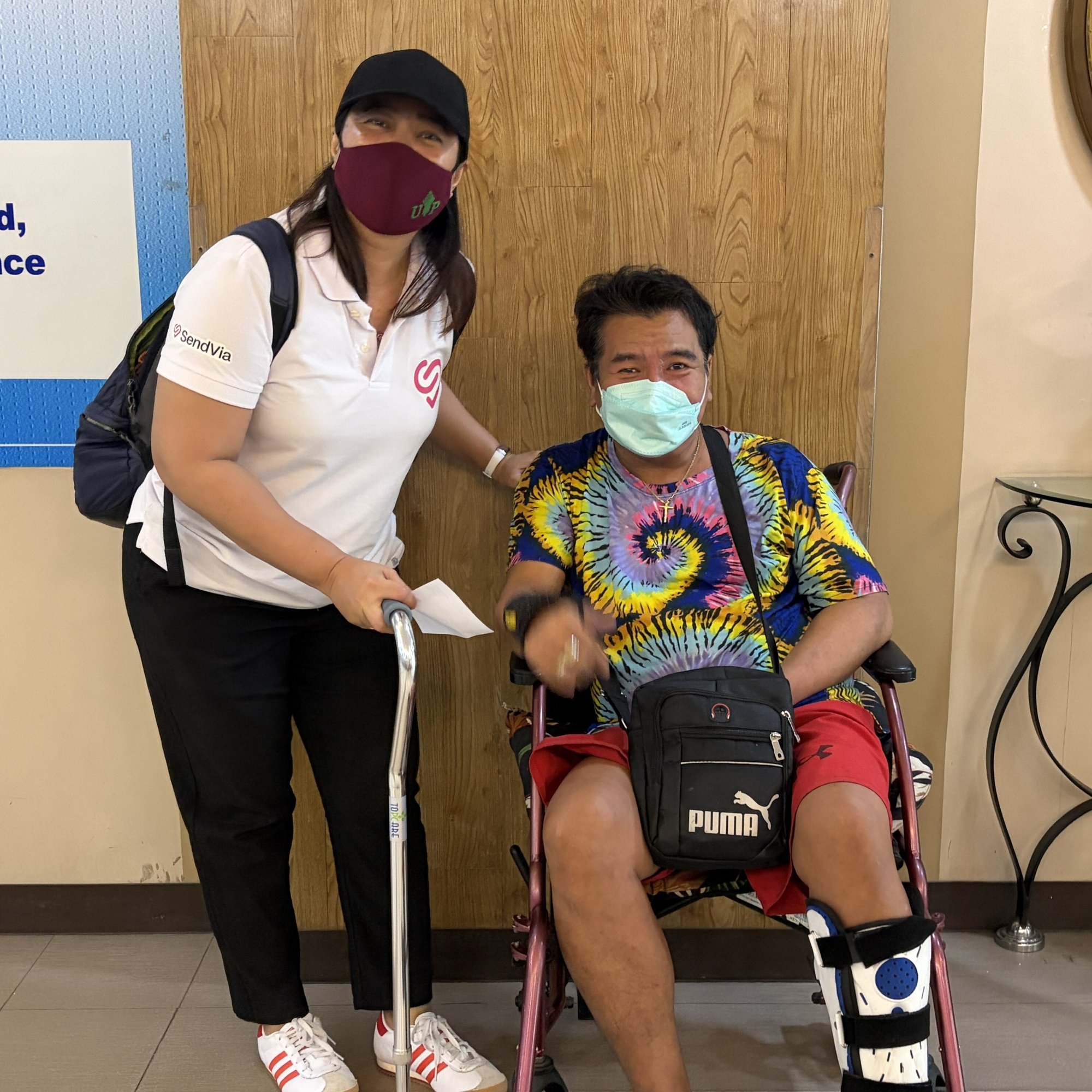 A man in a wheel chair sitting next to a Care Companion