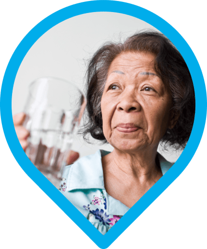 A Filipina grandma holding a glass of water